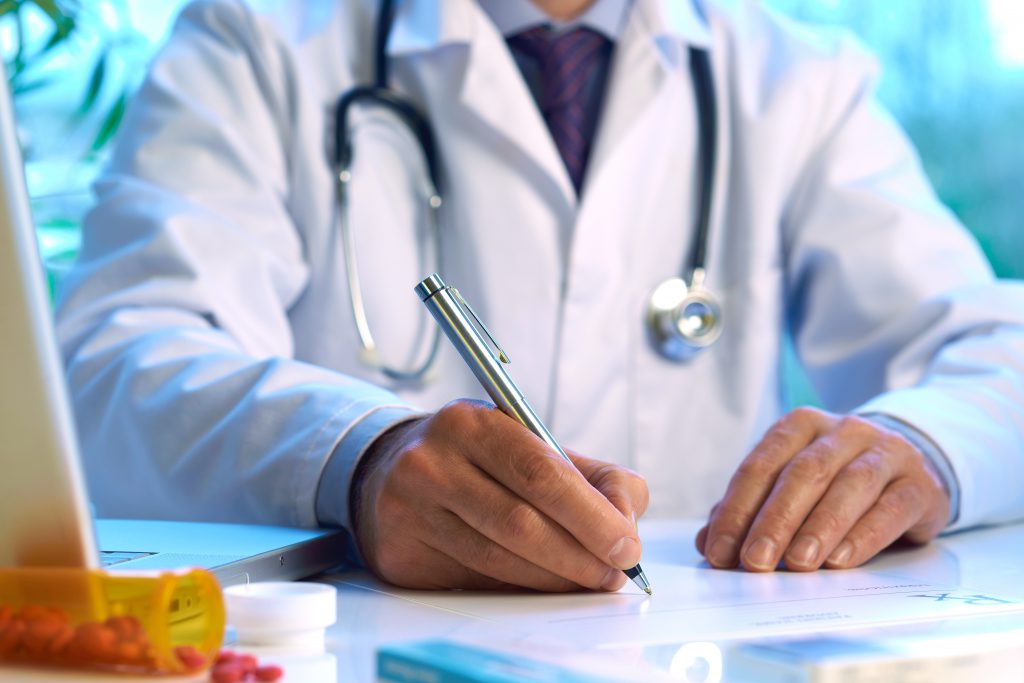 doctor in qatar writing prescription 