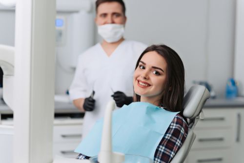 Smiling lady patient in doctor's chair. 