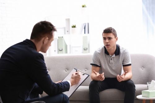 Young man talking to a therapist.