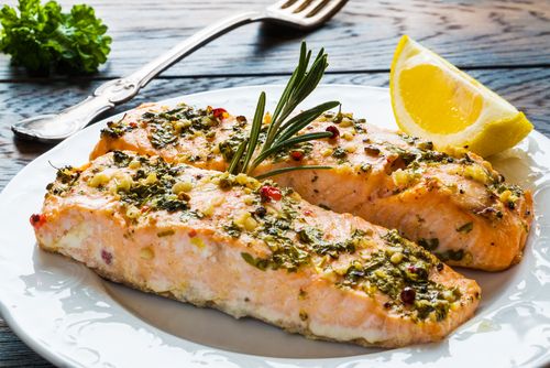Cooked salmon with parsley and spinach. 