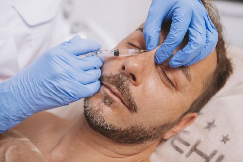 A man getting a liquid filler injected into his nose.