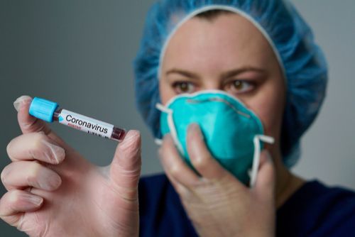 Woman holding the blood sample of a patient tested positive for coronavirus.