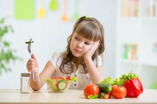 Girl looking at her healthy food in disgust.