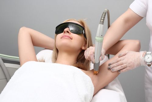 American woman getting laser hair removal for her armpits.