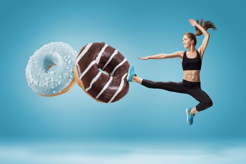 Woman kicking away donuts. 