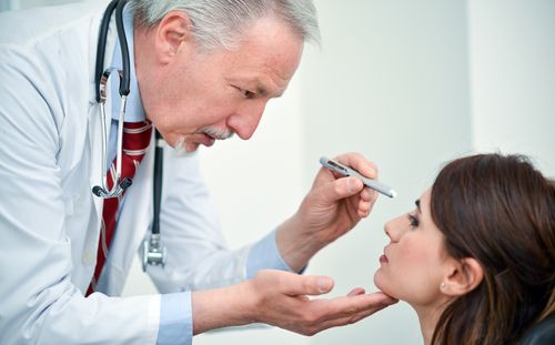 An ophthalmologist checking a patient. 