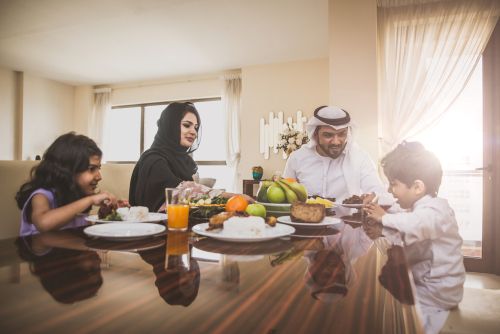 A happy Arabic family having lunch together.