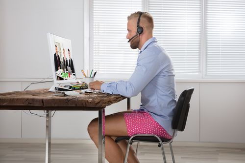 Man in shorts working from home.