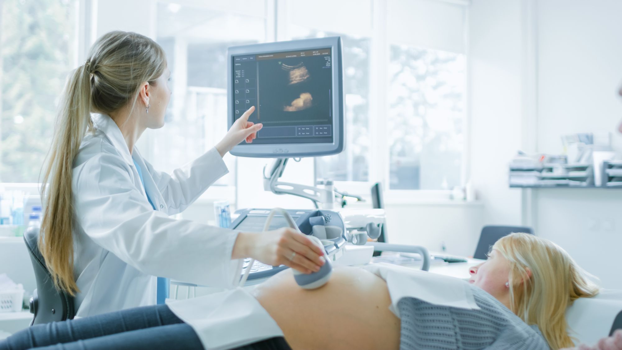 doctor taking pregnant patient's ultrasound