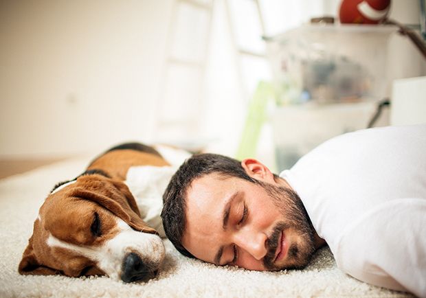happy man sleeping with dog